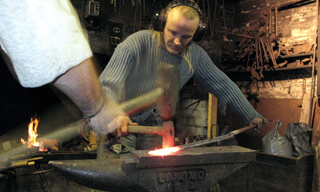 An artist blacksmith and a striker working as one