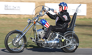 Peter Fonda rides a replica of the Captain America bike used in Easy Rider