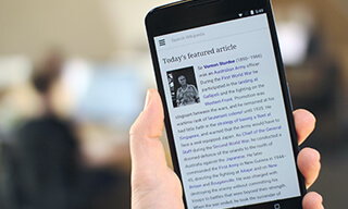 A smartphone displaying the homepage of the English Wikipedia